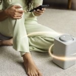 A woman setting up an air purifier